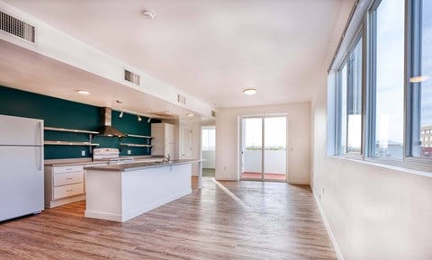 a kitchen with a large window and a white counter top